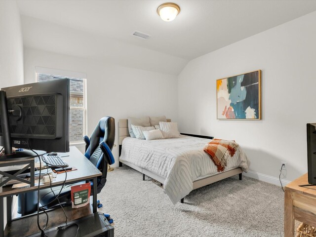 bedroom featuring baseboards, visible vents, carpet flooring, and lofted ceiling