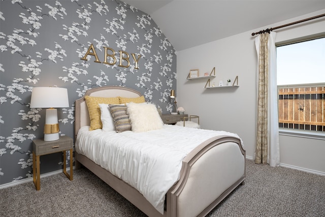 carpeted bedroom featuring baseboards and lofted ceiling
