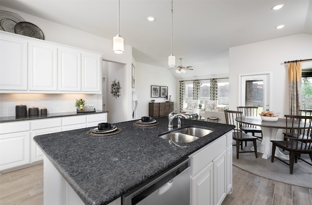 kitchen featuring stainless steel dishwasher, plenty of natural light, a sink, and light wood-type flooring