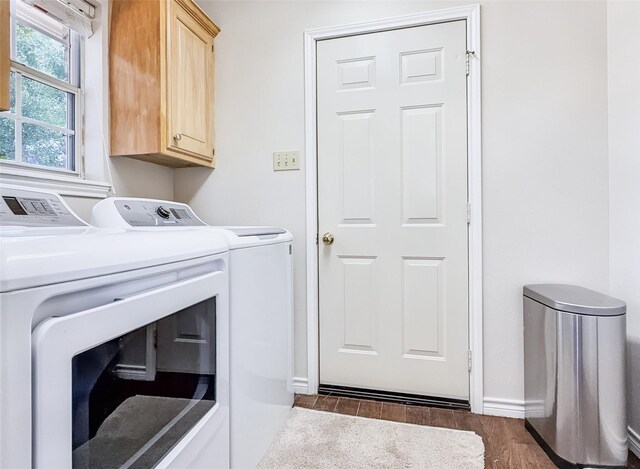washroom featuring baseboards, cabinet space, dark wood-style flooring, and independent washer and dryer