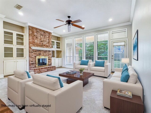 living room with visible vents, crown molding, a fireplace, ceiling fan, and recessed lighting