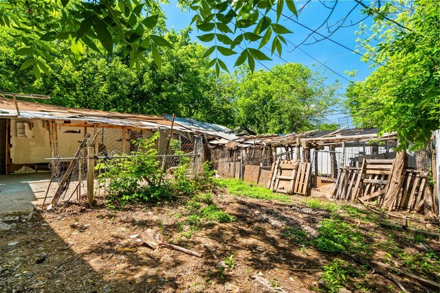 view of yard with an outdoor structure and fence