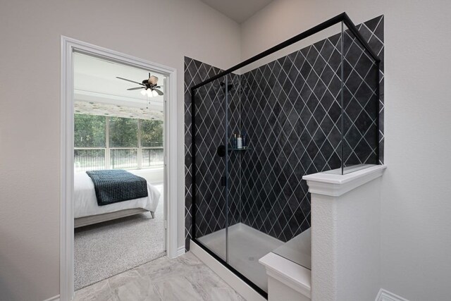 ensuite bathroom featuring connected bathroom, a walk in shower, marble finish floor, a ceiling fan, and baseboards