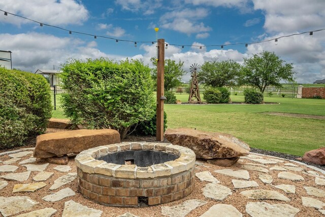 view of yard featuring fence and a fire pit