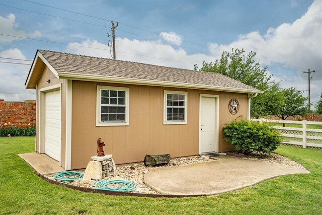 view of outbuilding featuring fence and an outdoor structure