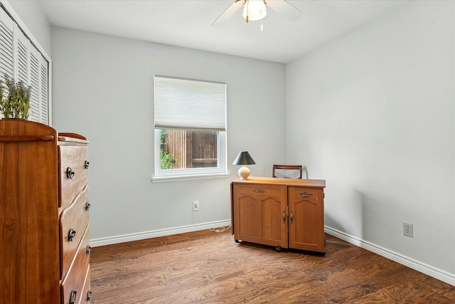 bedroom with baseboards, a ceiling fan, a closet, and wood finished floors