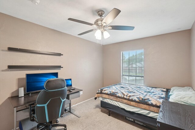 carpeted bedroom with baseboards and a ceiling fan