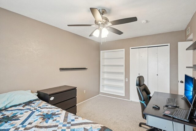 carpeted bedroom with baseboards, visible vents, ceiling fan, and a closet