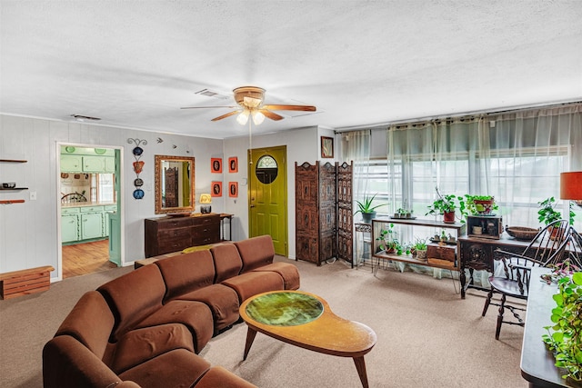 208 Johnson St, Seagoville, TX 75159 - carpeted living room featuring visible vents, a textured ceiling, and ceiling fan