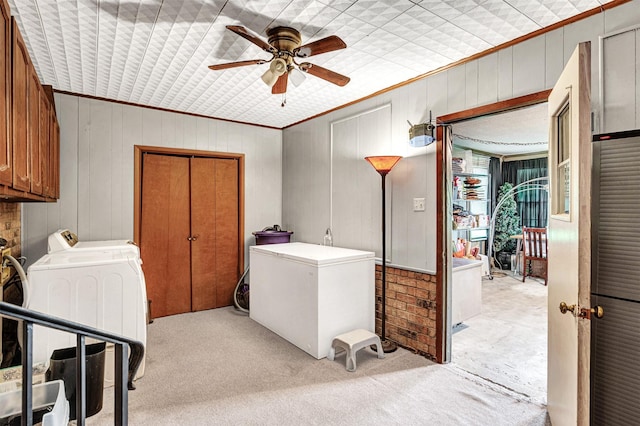 208 Johnson St, Seagoville, TX 75159 - clothes washing area with cabinet space, crown molding, ceiling fan, light colored carpet, and wood walls