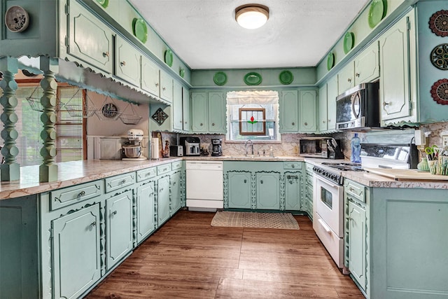208 Johnson St, Seagoville, TX 75159 - kitchen with a sink, tasteful backsplash, white appliances, and dark wood-type flooring