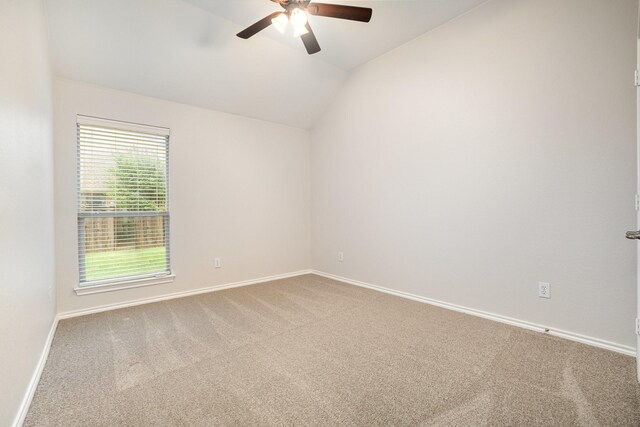 spare room featuring carpet floors, a ceiling fan, baseboards, and vaulted ceiling