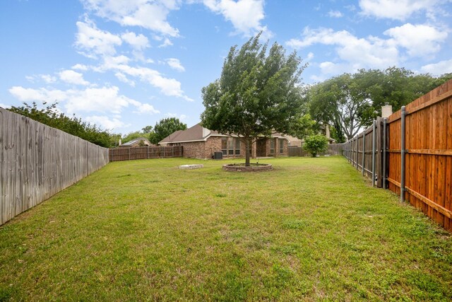 view of yard with a fenced backyard