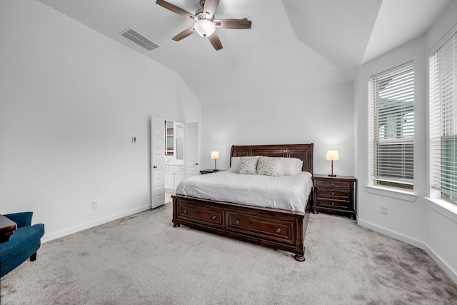 bedroom with visible vents, vaulted ceiling, multiple windows, and light colored carpet