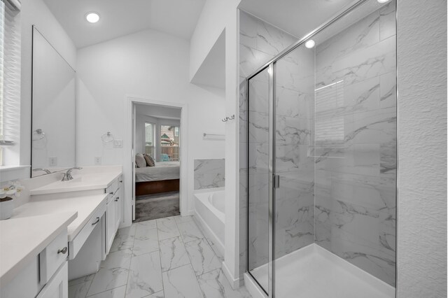 ensuite bathroom featuring connected bathroom, vanity, a marble finish shower, marble finish floor, and vaulted ceiling