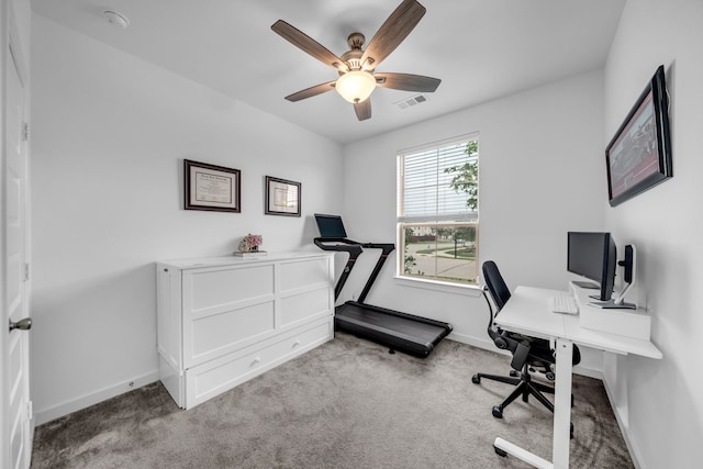 carpeted home office featuring visible vents, baseboards, and ceiling fan