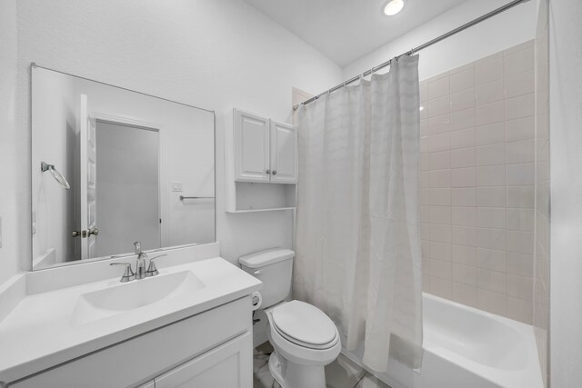 bathroom with vanity, toilet, and shower / bath combo with shower curtain