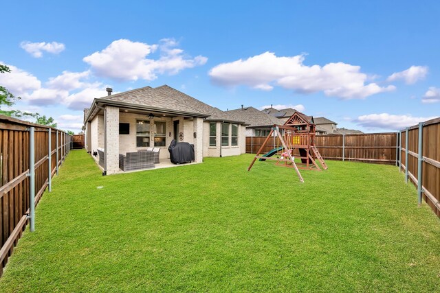 back of property featuring ceiling fan, roof with shingles, brick siding, a fenced backyard, and a playground