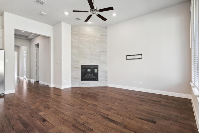 unfurnished living room featuring dark wood-style flooring, a ceiling fan, visible vents, and recessed lighting