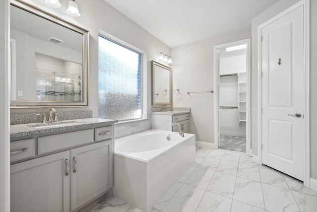 bathroom featuring visible vents, a sink, and marble finish floor