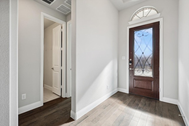 entrance foyer with baseboards, visible vents, and wood finished floors
