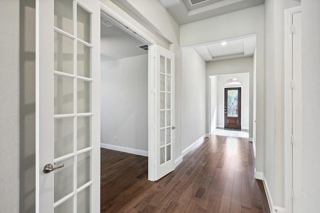 hallway featuring baseboards, french doors, and dark wood-style flooring