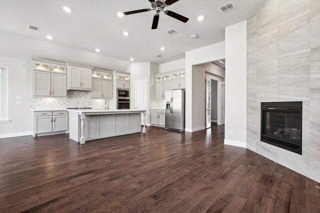 kitchen featuring visible vents, a ceiling fan, dark wood-style flooring, and stainless steel appliances
