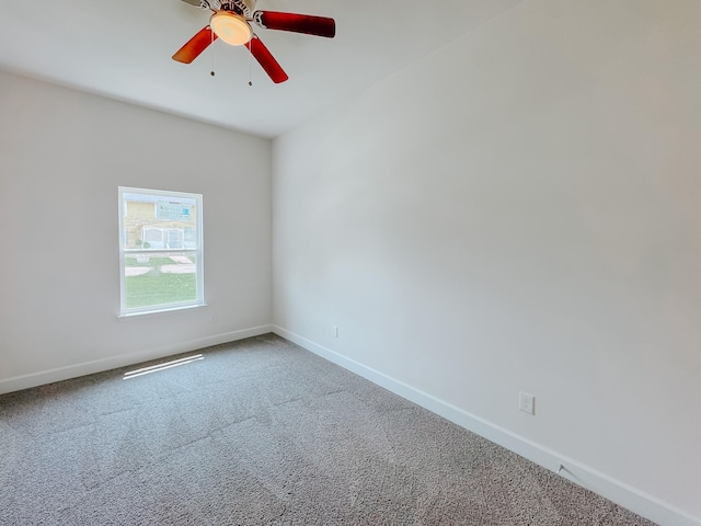 carpeted empty room with baseboards and ceiling fan
