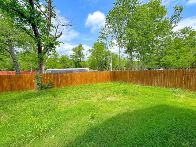 view of yard with a fenced backyard