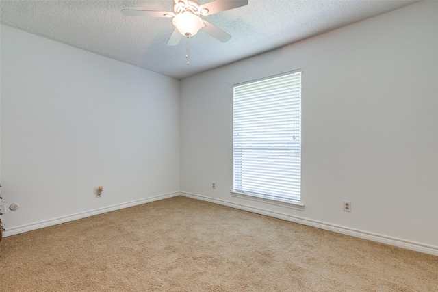 unfurnished room with a healthy amount of sunlight, carpet, and a ceiling fan