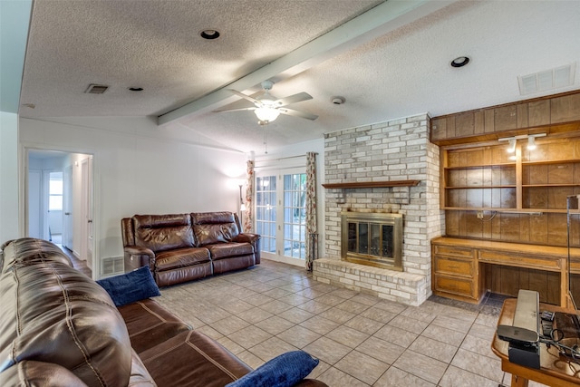 living room featuring a textured ceiling, visible vents, a wealth of natural light, and ceiling fan