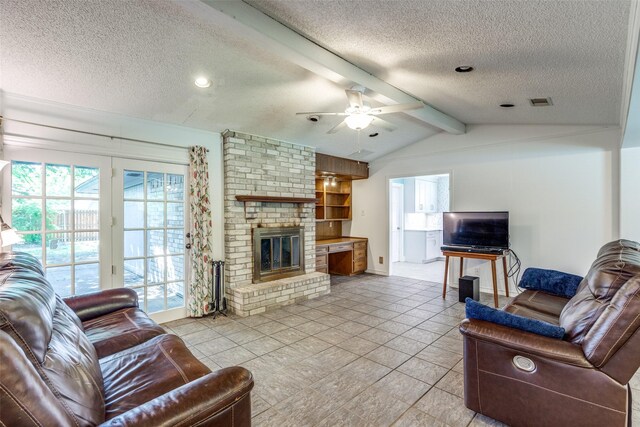 living room featuring vaulted ceiling with beams, a ceiling fan, a textured ceiling, and a fireplace