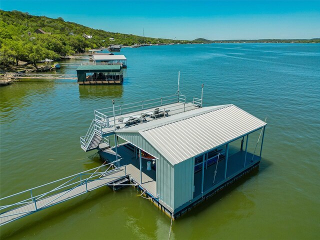 dock area with a water view and boat lift