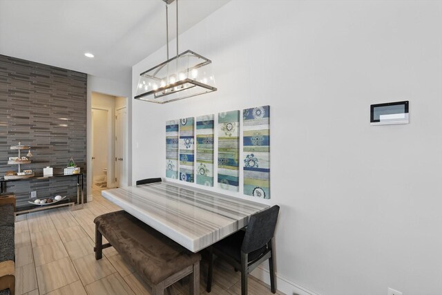 dining space with baseboards, recessed lighting, and a notable chandelier