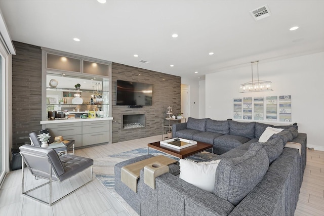 living area with visible vents, recessed lighting, and a fireplace