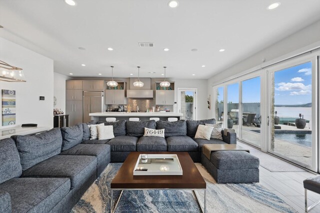 living area with a water view and recessed lighting