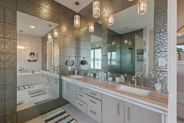 full bathroom featuring double vanity, a sink, a shower stall, and tasteful backsplash
