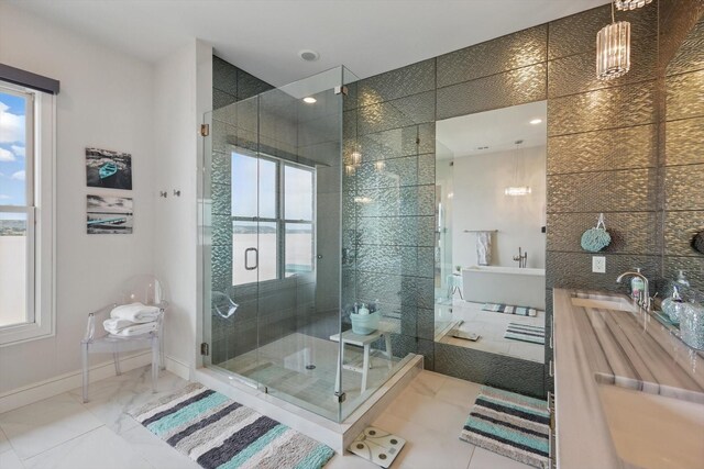 bathroom featuring a sink, baseboards, plenty of natural light, and a stall shower