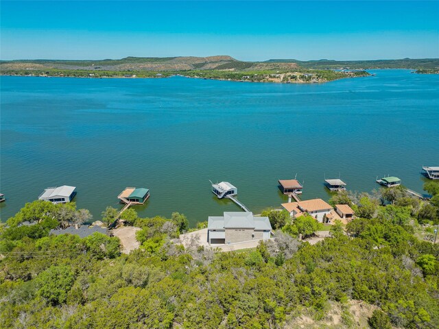 birds eye view of property with a water and mountain view