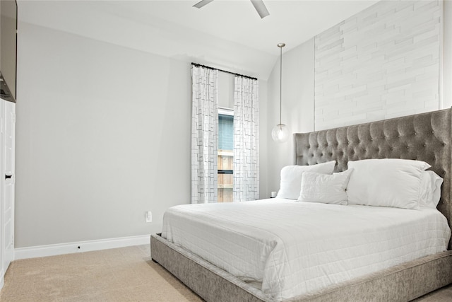 bedroom featuring carpet floors, baseboards, ceiling fan, and vaulted ceiling