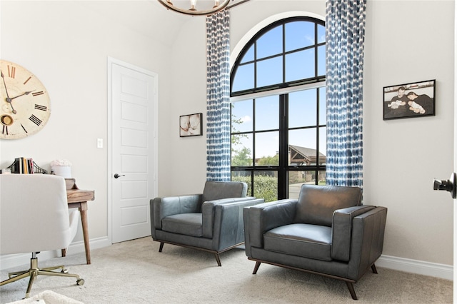 living area with baseboards, carpet flooring, a chandelier, and high vaulted ceiling