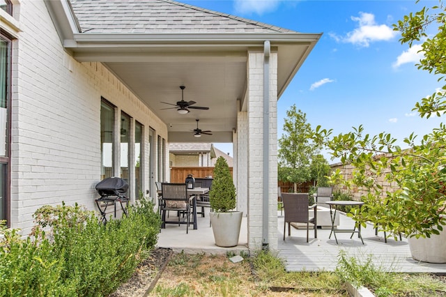 view of patio / terrace featuring fence, a ceiling fan, outdoor dining area, and area for grilling