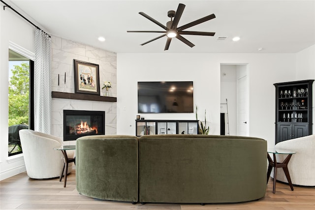 living room featuring ceiling fan, recessed lighting, wood finished floors, and a premium fireplace