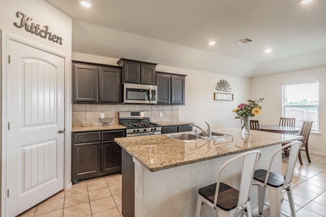 kitchen featuring a sink, appliances with stainless steel finishes, light tile patterned floors, and visible vents