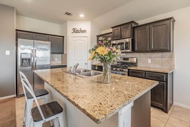 kitchen with visible vents, a sink, appliances with stainless steel finishes, and light tile patterned floors
