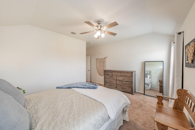 bedroom with a ceiling fan, vaulted ceiling, carpet, and visible vents