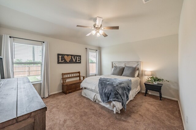 bedroom featuring a ceiling fan, baseboards, and light colored carpet