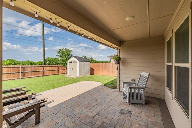 view of patio with an outdoor structure, a fenced backyard, and a storage shed