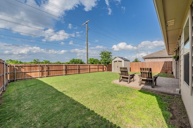 view of yard featuring a fenced backyard, an outdoor structure, a patio area, and a shed