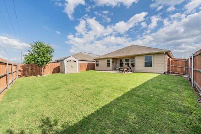 back of property featuring a patio, an outbuilding, a shed, and a fenced backyard